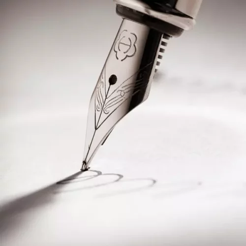 plume de stylo tracant des lignes sur du papier manuscrit